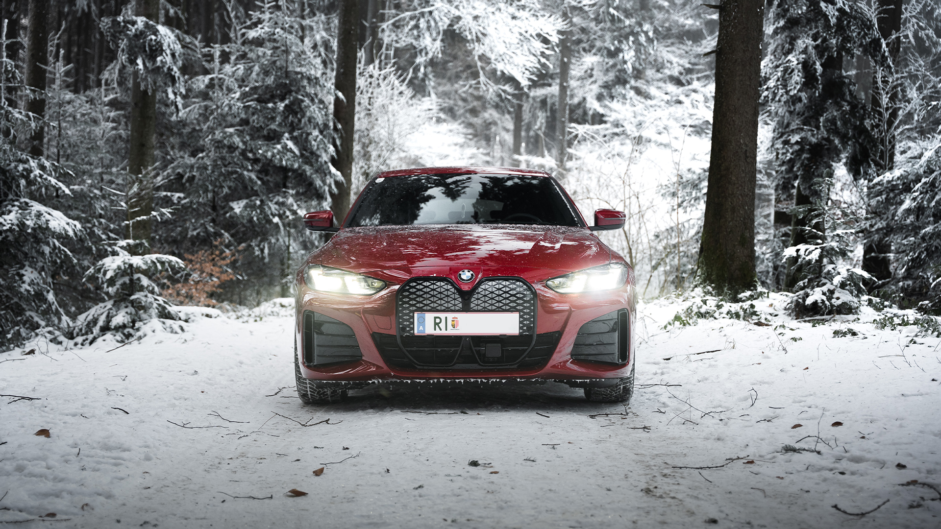 BMW i4 on snowy forest road